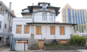 A boarded up house stands just steps from the casino. Photograph - Jessica Glenza for the Guardian